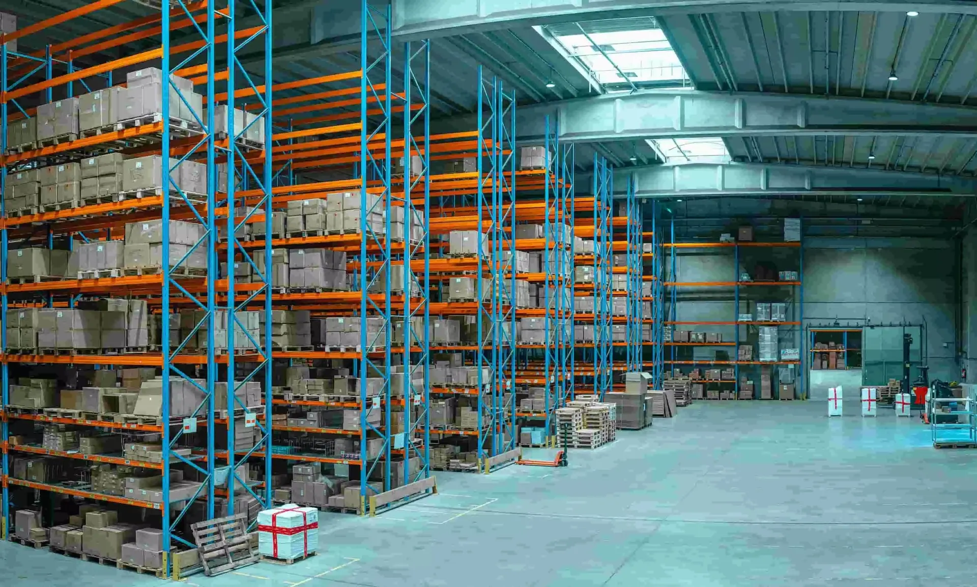 Large distribution warehouse with high-bay pallet racking and stocked aisles